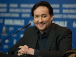 John Cusack is a name synonymous with relatable characters, quirky charm, and a filmography that has brought joy to audiences for over four decades. But Cusack's impact goes beyond box office success. He's a versatile actor, a dedicated producer, and a writer who isn't afraid to take risks. Early Life and Stepping into the Spotlight (1966-Present) Born in Evanston, Illinois in 1966, John Cusack comes from a creative family. His father, Dick Cusack, is a filmmaker, and his sisters, Joan and Ann Cusack, are both successful actresses. It's no surprise then, that Cusack began acting at a young age. His professional career kicked off in the early 1980s, and by the mid-80s, he was a rising star. The Breakout Years: From Teen Angst to Enduring Classics (1980s-1990s) The 1980s saw Cusack become a fixture in teen coming-of-age films. Who can forget his iconic roles in "Sixteen Candles," "Better Off Dead," and the ever-quoted "Say Anything..."? These films showcased his comedic timing and ability to connect with audiences on a personal level. As the 90s arrived, Cusack's career took a more diverse turn. He transitioned seamlessly into more dramatic roles, captivating audiences in films like "Bullets Over Broadway," "The Shawshank Redemption" (though his scenes were ultimately cut), and the critically acclaimed "The Thin Red Line." Beyond the Leading Man: Exploring Indie Films and Genre-Bending Roles (1990s-Present) Cusack has never been afraid to push boundaries. He embraced independent cinema, starring in thought-provoking films like "Being John Malkovich" and "High Fidelity," both of which garnered him critical acclaim and solidified his place as a Hollywood heavyweight. His ability to switch between genres is another hallmark of his career. From action thrillers like "Con Air" to romantic comedies like "America's Sweethearts," Cusack consistently delivers memorable performances. More Than Just Acting: A Multifaceted Creative (1990s-Present) Cusack's talents extend beyond acting. He's a passionate writer and producer, often collaborating on projects that reflect his own creative vision. This dedication to storytelling further cements his place as a well-rounded artist. A Look at His Net Worth and Enduring Legacy (2024) With a successful career spanning four decades, it's no wonder John Cusack's net worth is estimated to be around $50 million according to CelebrityNetWorth. But his true legacy lies in the characters he's brought to life and the impact he's had on audiences. John Cusack: Still Going Strong John Cusack remains an active force in Hollywood. He continues to take on diverse roles and advocate for causes he believes in. Whether it's portraying a political activist in "14 Days in July" or lending his voice to animated films, Cusack's dedication to his craft is undeniable.